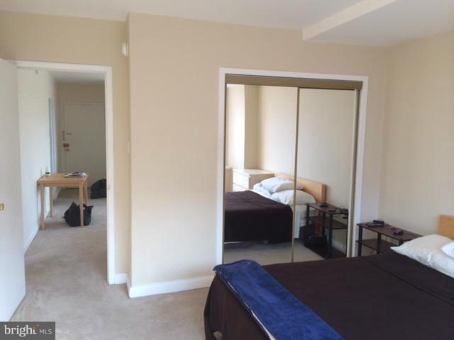 1121 Arlington Boulevard, Unit 842 Arlington, VA 22209 - Photo 12 of 30 a bedroom with a bed and wooden floor