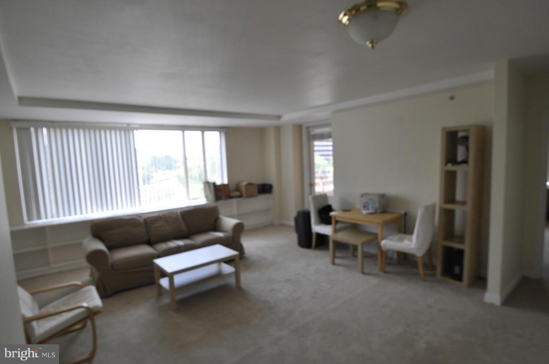1121 Arlington Boulevard, Unit 842 Arlington, VA 22209 - Photo 21 of 30 a living room with furniture and a window