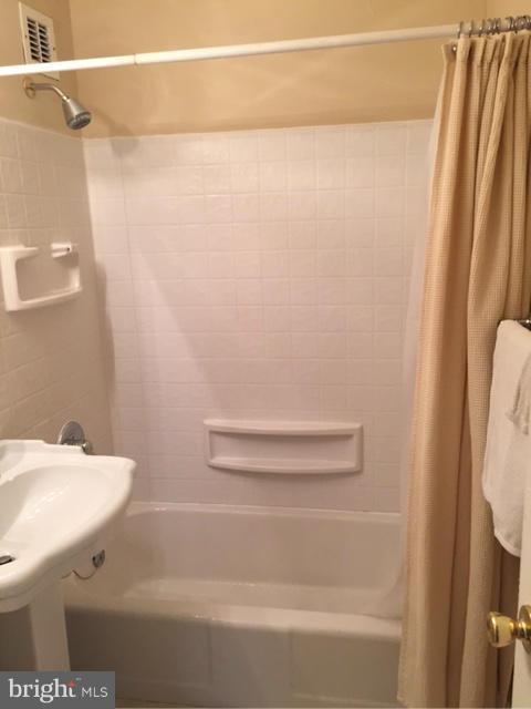 1121 Arlington Boulevard, Unit 842 Arlington, VA 22209 - Photo 4 of 30 a bathroom with a sink and a mirror