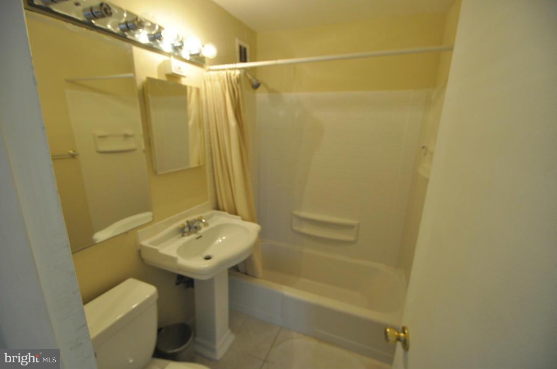 1121 Arlington Boulevard, Unit 842 Arlington, VA 22209 - Photo 6 of 30 a bathroom with a sink toilet and shower
