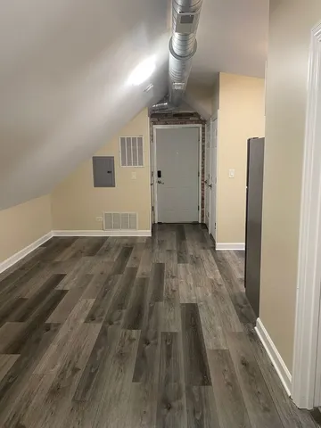 a view of empty room with wooden floor