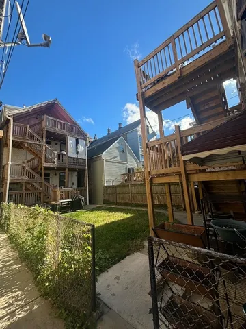 a view of a house with backyard porch and sitting area
