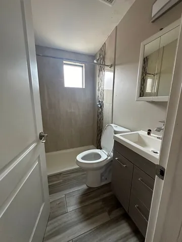a bathroom with a toilet a sink and shower