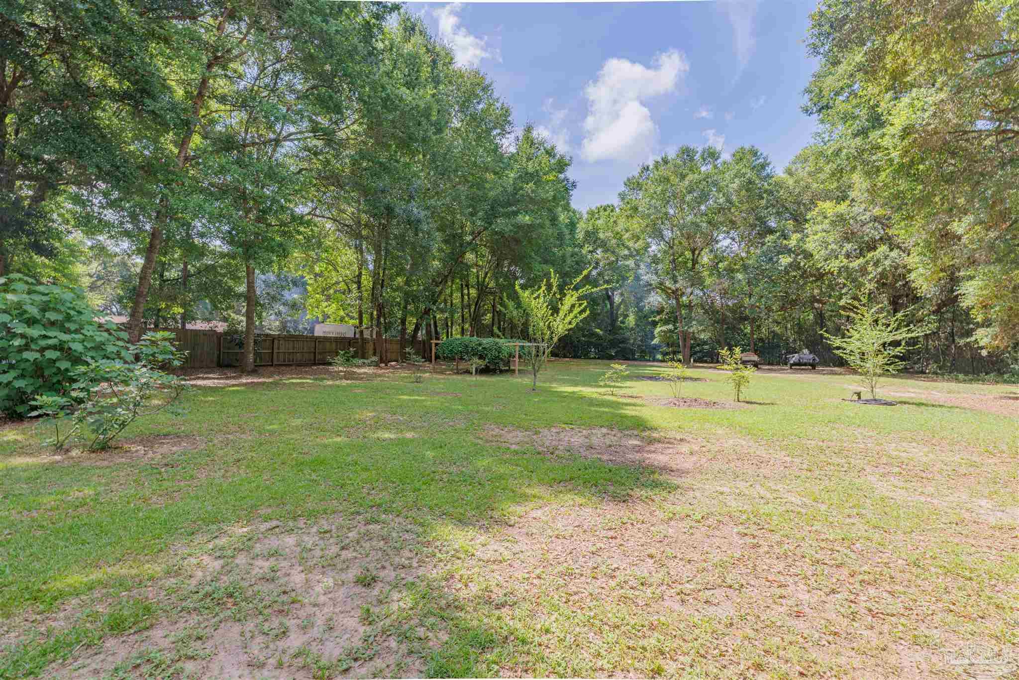 5049 Guernsey Road Pace, FL 32571 - Photo 61 of 61 a view of a swimming pool and a yard