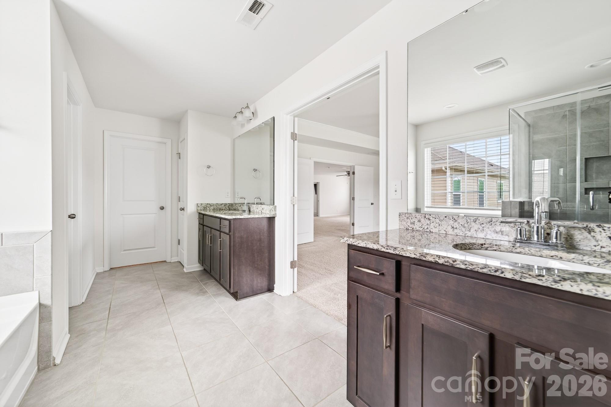 5972 Redwood Pine Road Concord, NC 28027 - Photo 25 of 37 a bathroom with a granite countertop sink and a mirror