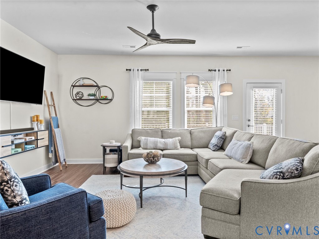 12320 Petrel Crossing Midlothian, VA 23112 - Photo 11 of 34 a living room with furniture a flat screen tv and a window