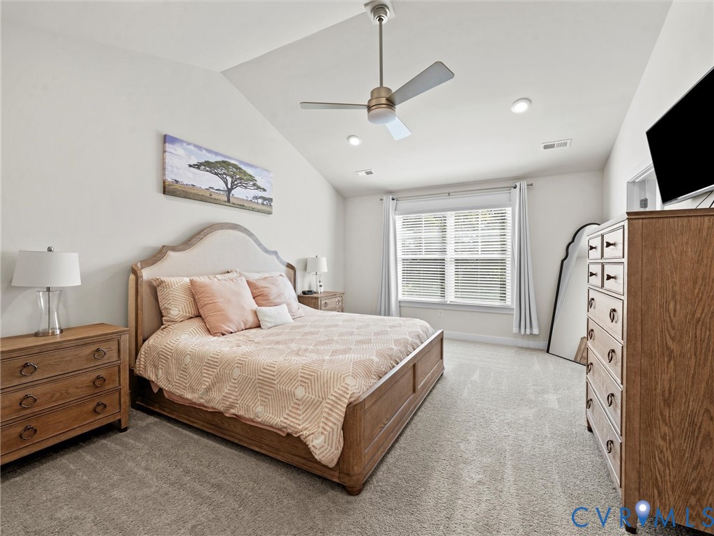 12320 Petrel Crossing Midlothian, VA 23112 - Photo 16 of 34 a spacious bedroom with a bed and a flat screen tv