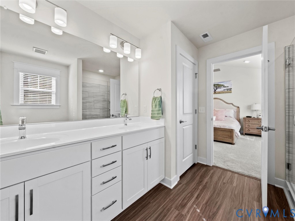 12320 Petrel Crossing Midlothian, VA 23112 - Photo 20 of 34 a spacious bathroom with a double vanity sink a large mirror and shower