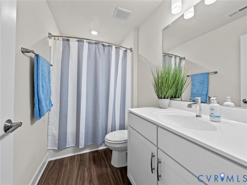 12320 Petrel Crossing Midlothian, VA 23112 - Photo 25 of 34 a bathroom with a sink a toilet and shower curtain