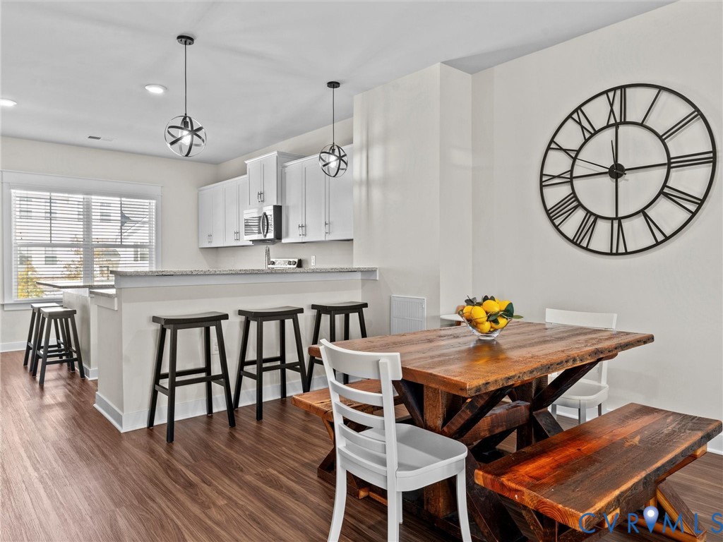 12320 Petrel Crossing Midlothian, VA 23112 - Photo 3 of 34 a view of a dining room with furniture and wooden floor