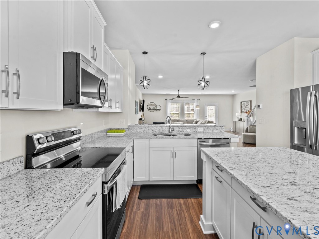 12320 Petrel Crossing Midlothian, VA 23112 - Photo 7 of 34 a kitchen with stainless steel appliances granite countertop a sink stove and refrigerator
