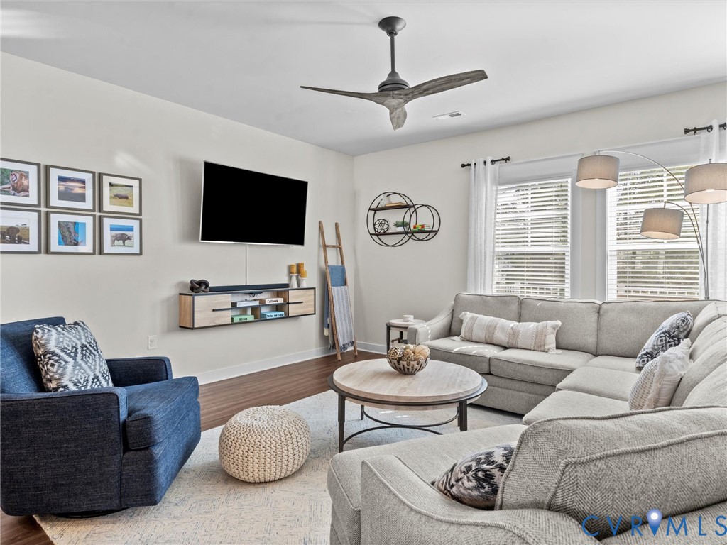 12320 Petrel Crossing Midlothian, VA 23112 - Photo 10 of 34 a living room with furniture a flat screen tv and a large window