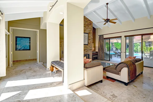 a living room with a bed furniture and a large window