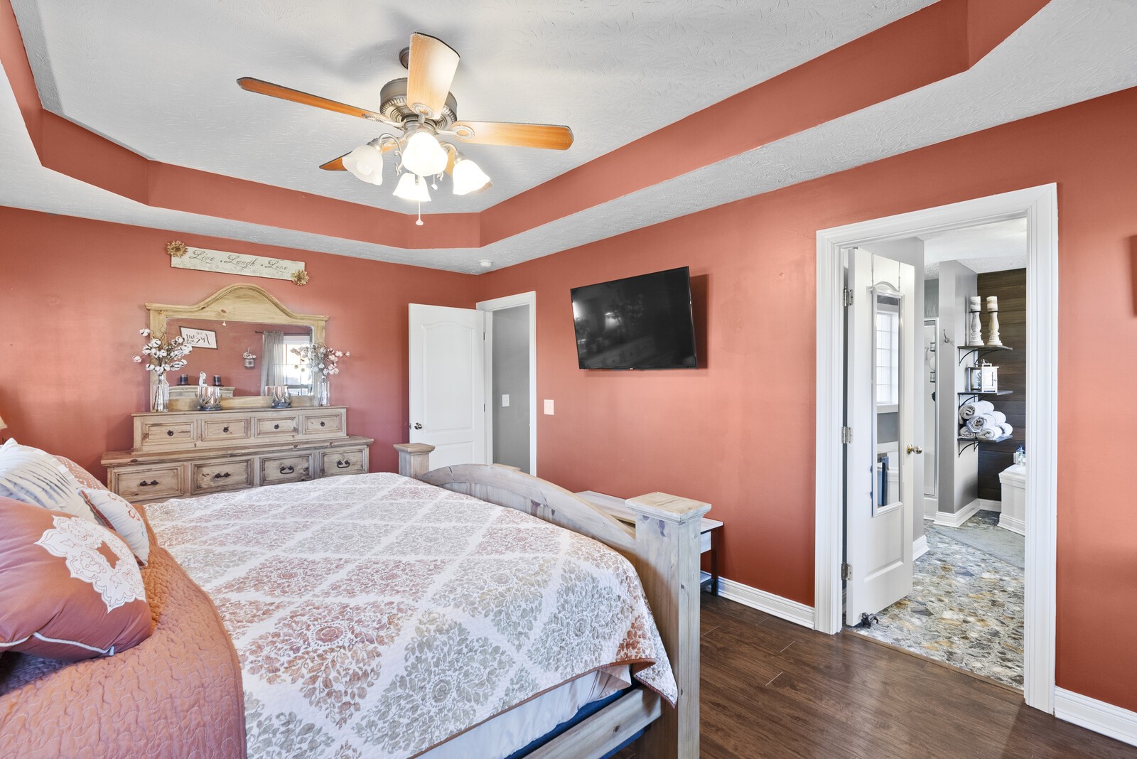 101 Brandy Hollow Road Portland, TN 37148 - Photo 22 of 50 a bedroom with a bed and a chandelier with a flat tv screen