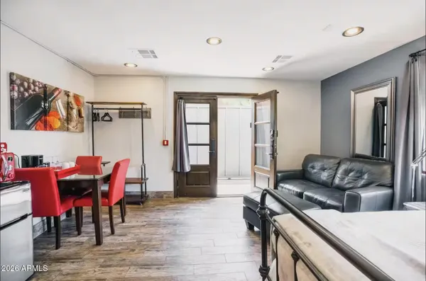 a living room with furniture and a wooden floor