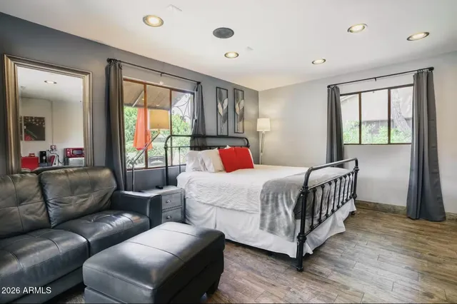 a bedroom with a bed couch and a window