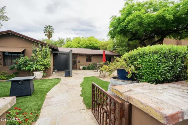 a view of a house with backyard and sitting area