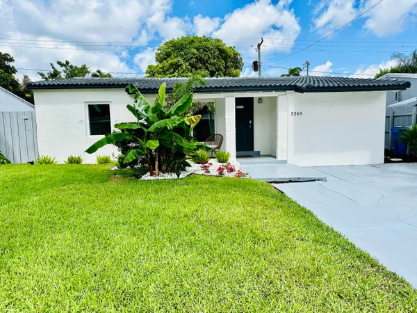 a front view of house with garden