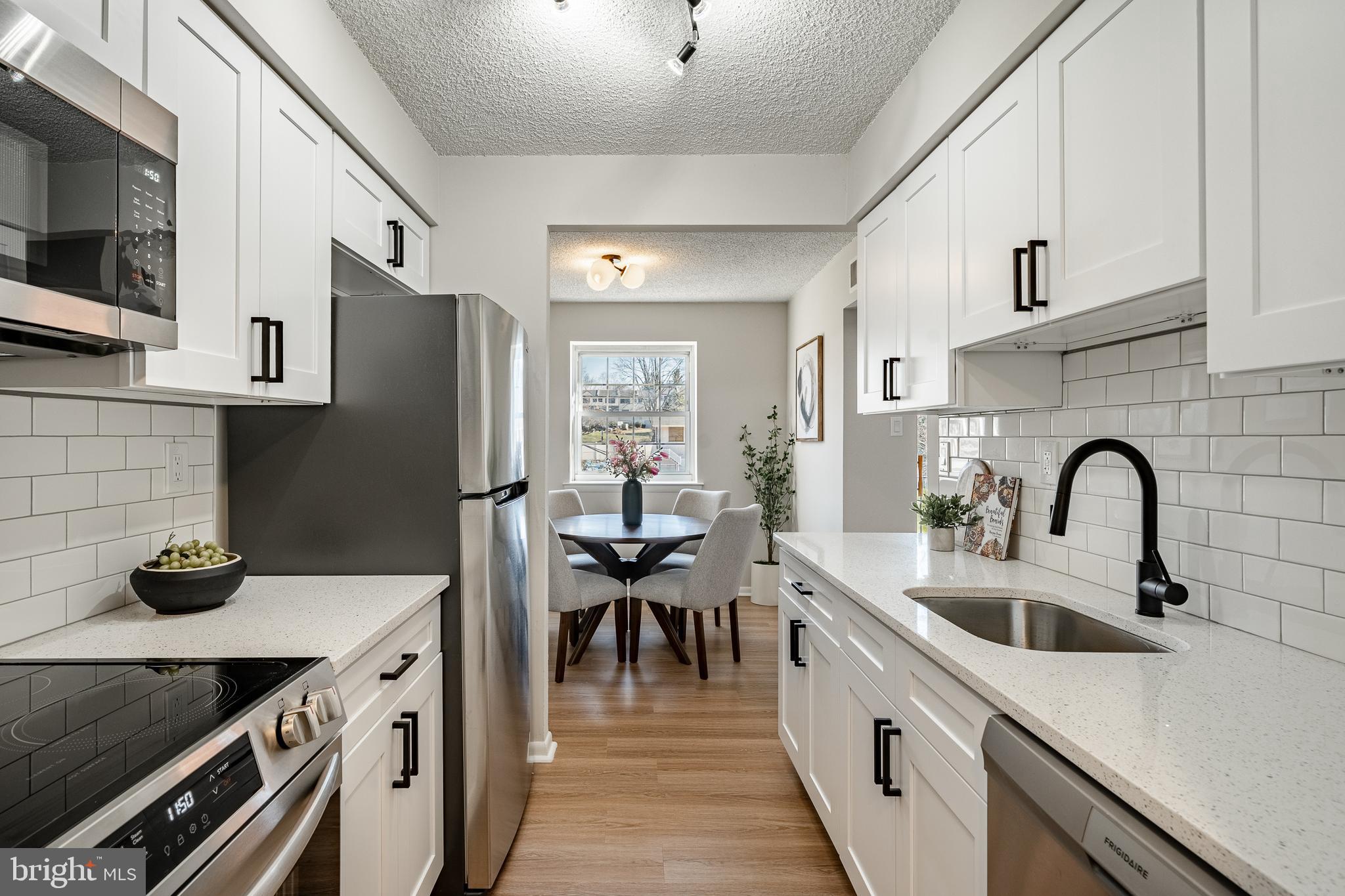 a kitchen with stainless steel appliances a sink stove and refrigerator