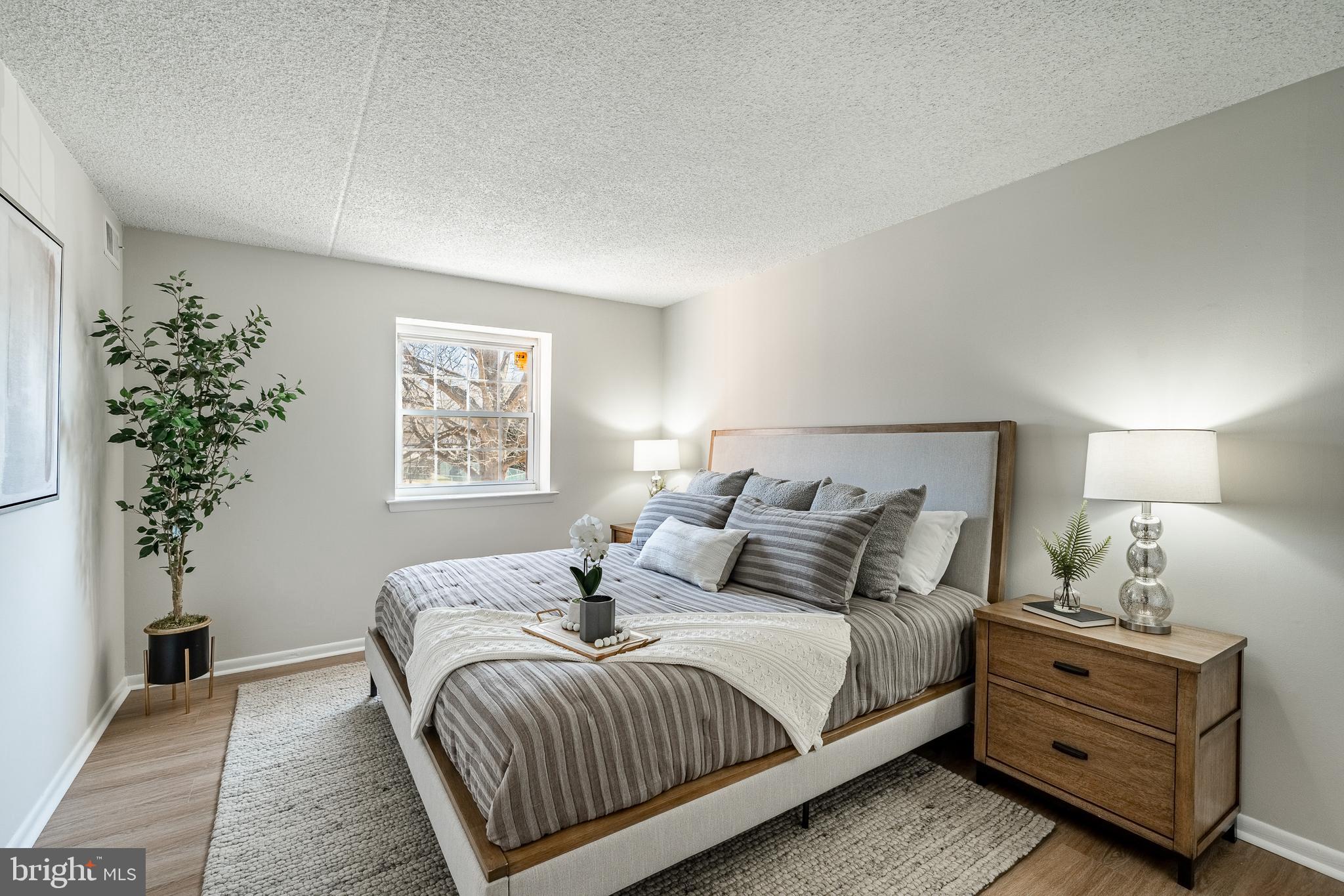 2714 Eagle Road, Unit 2714 West Chester, PA 19382 - Photo 15 of 25 a bedroom with a bed and a potted plant