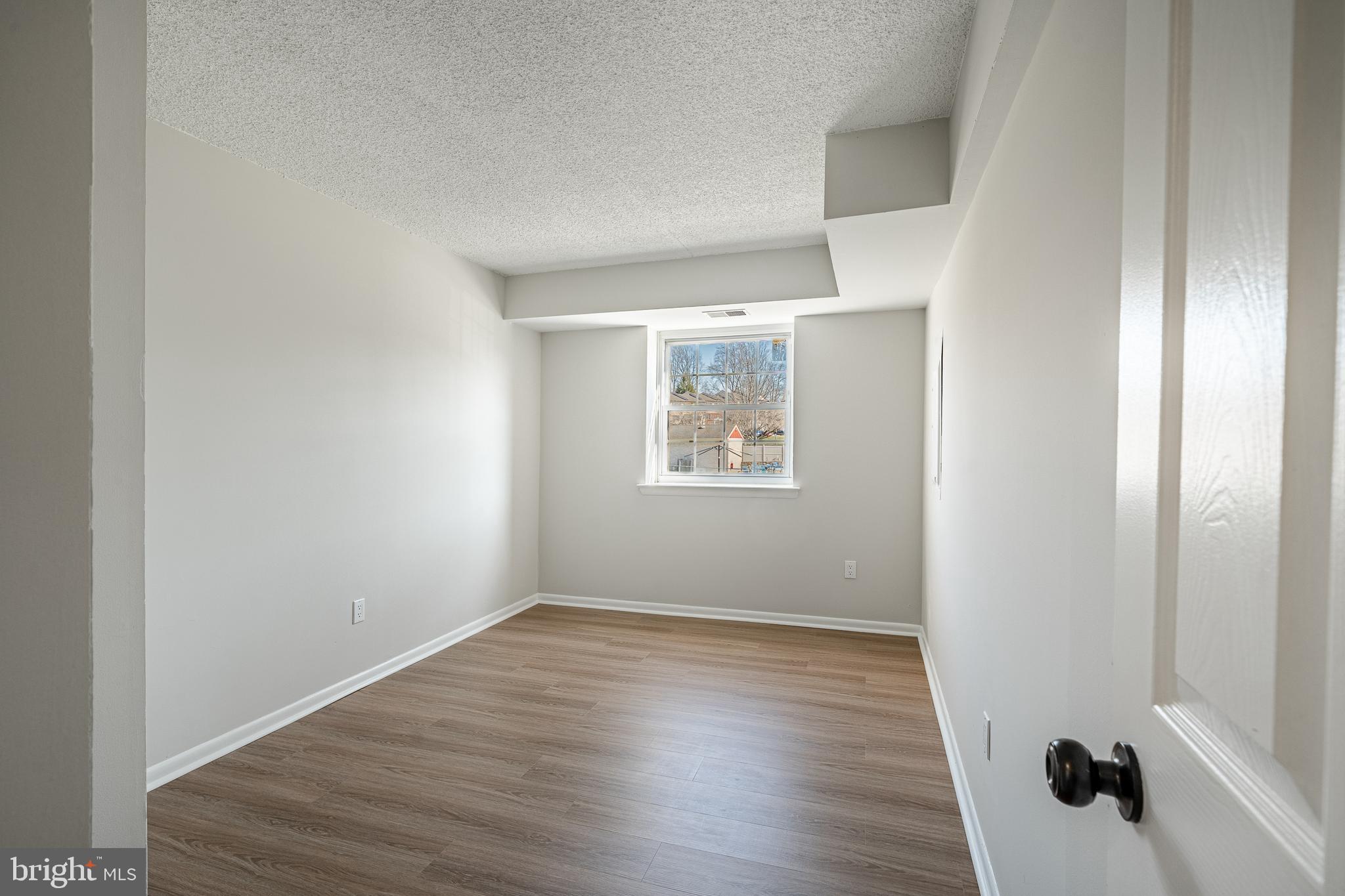 2714 Eagle Road, Unit 2714 West Chester, PA 19382 - Photo 20 of 25 an empty room with wooden floor and windows