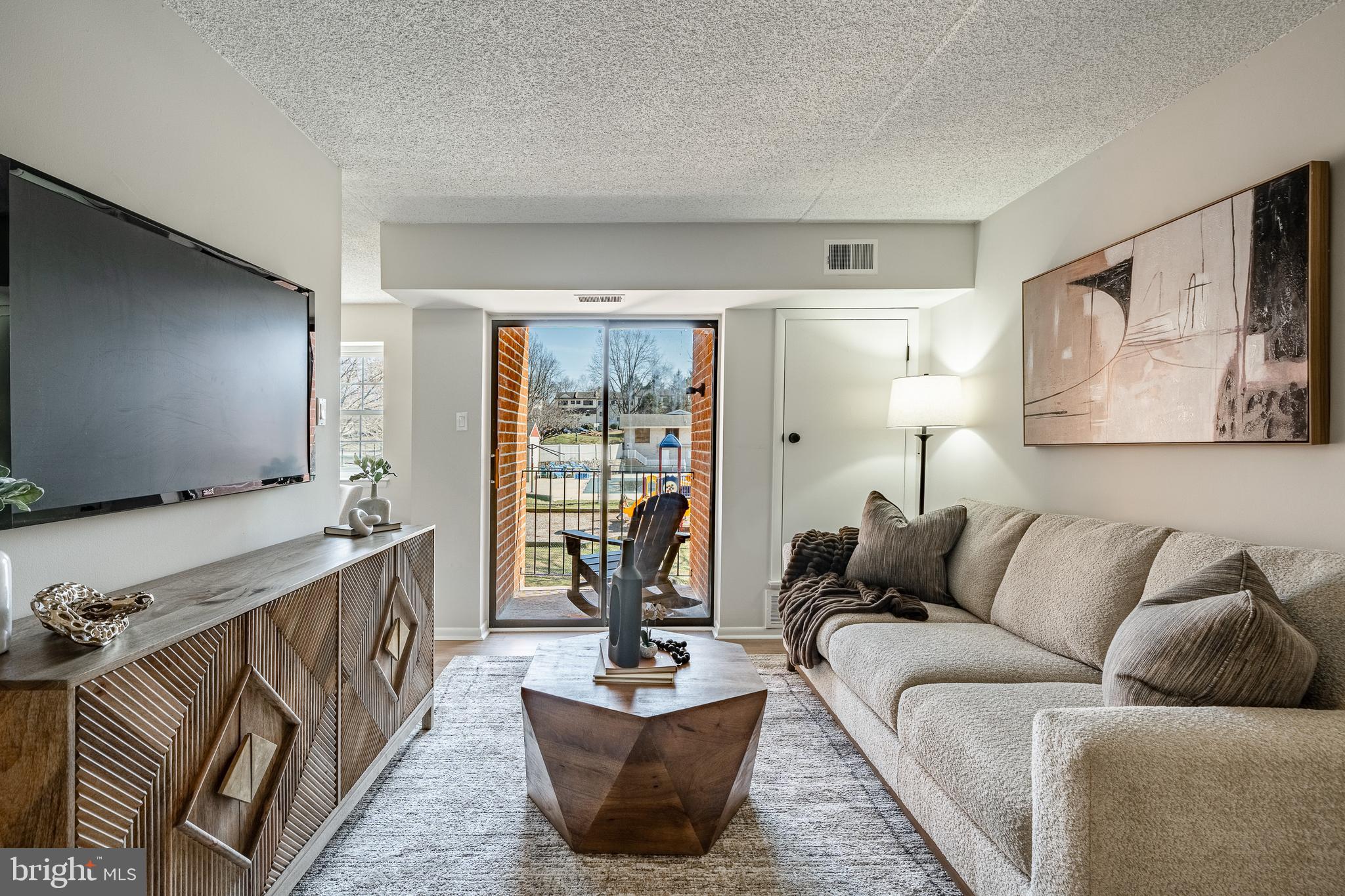 2714 Eagle Road, Unit 2714 West Chester, PA 19382 - Photo 6 of 25 a living room with furniture and a flat screen tv