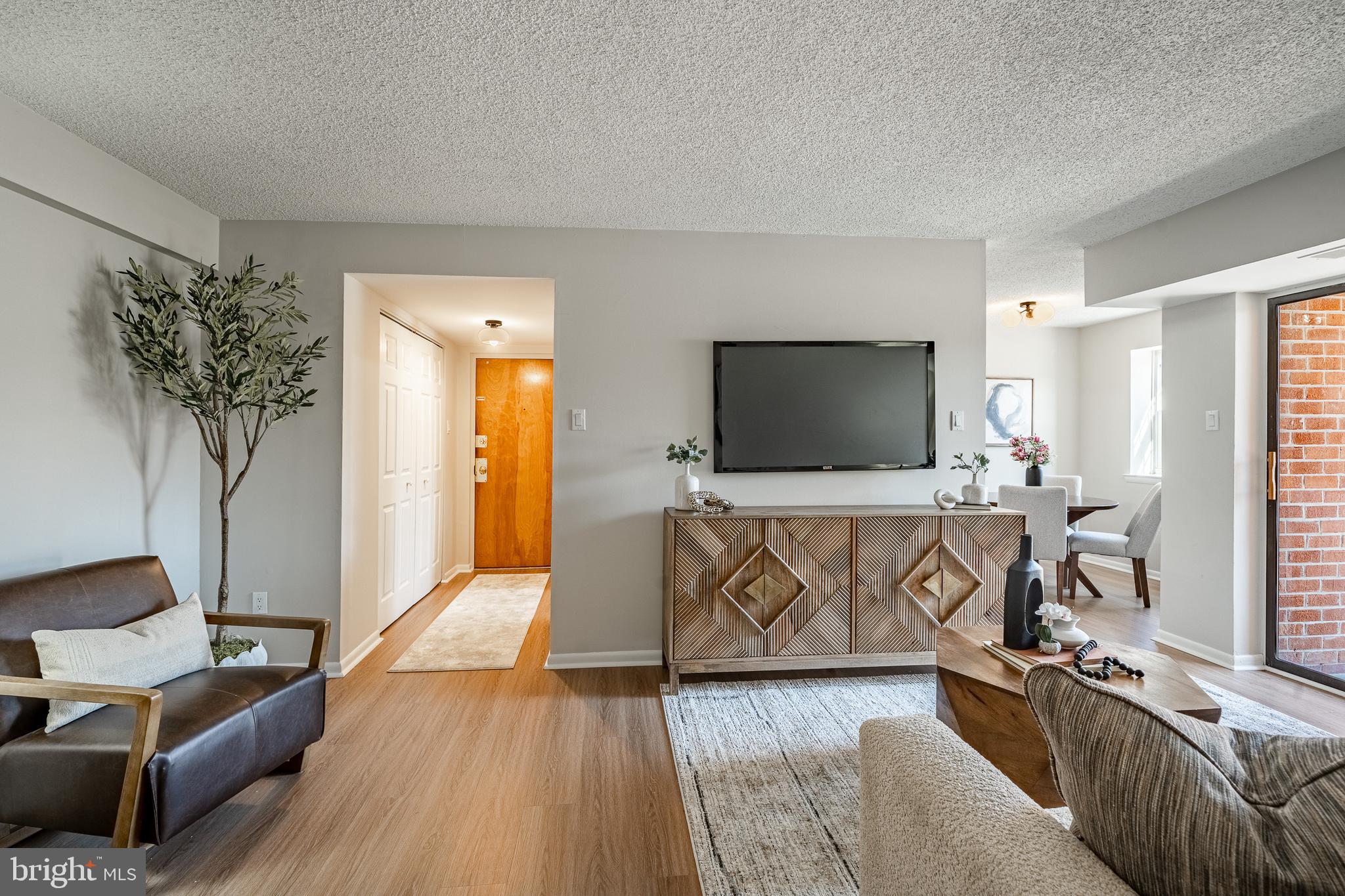 2714 Eagle Road, Unit 2714 West Chester, PA 19382 - Photo 7 of 25 a living room with furniture and a flat screen tv