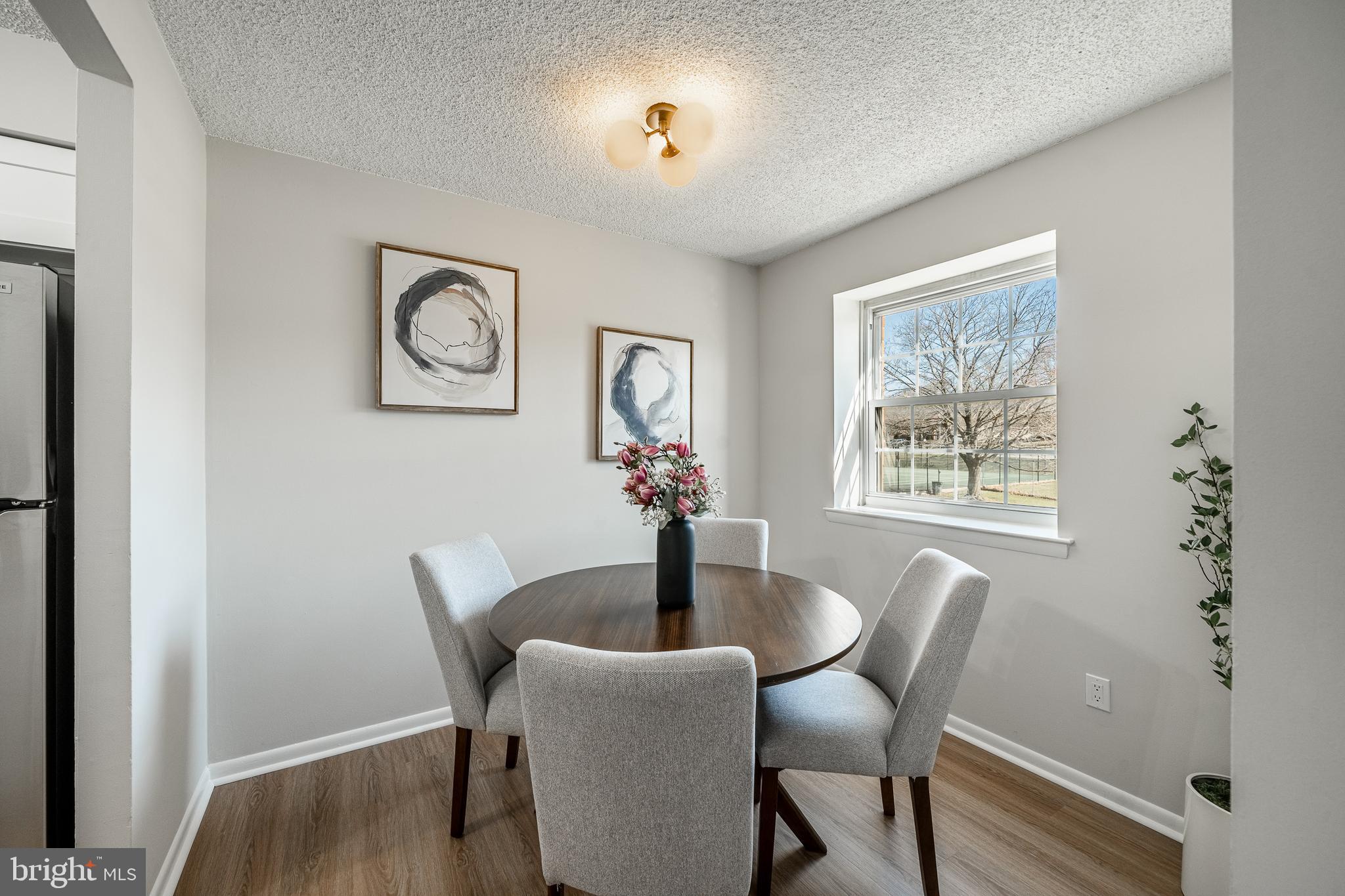 2714 Eagle Road, Unit 2714 West Chester, PA 19382 - Photo 8 of 25 a dining room with furniture potted plants and wooden floor