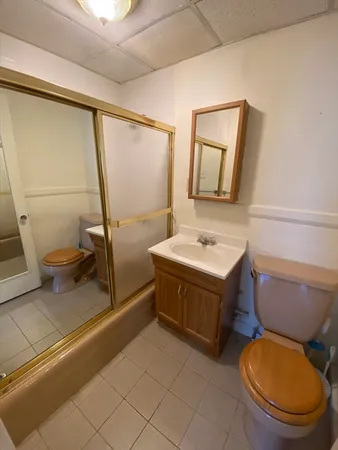 a bathroom with a sink toilet and mirror