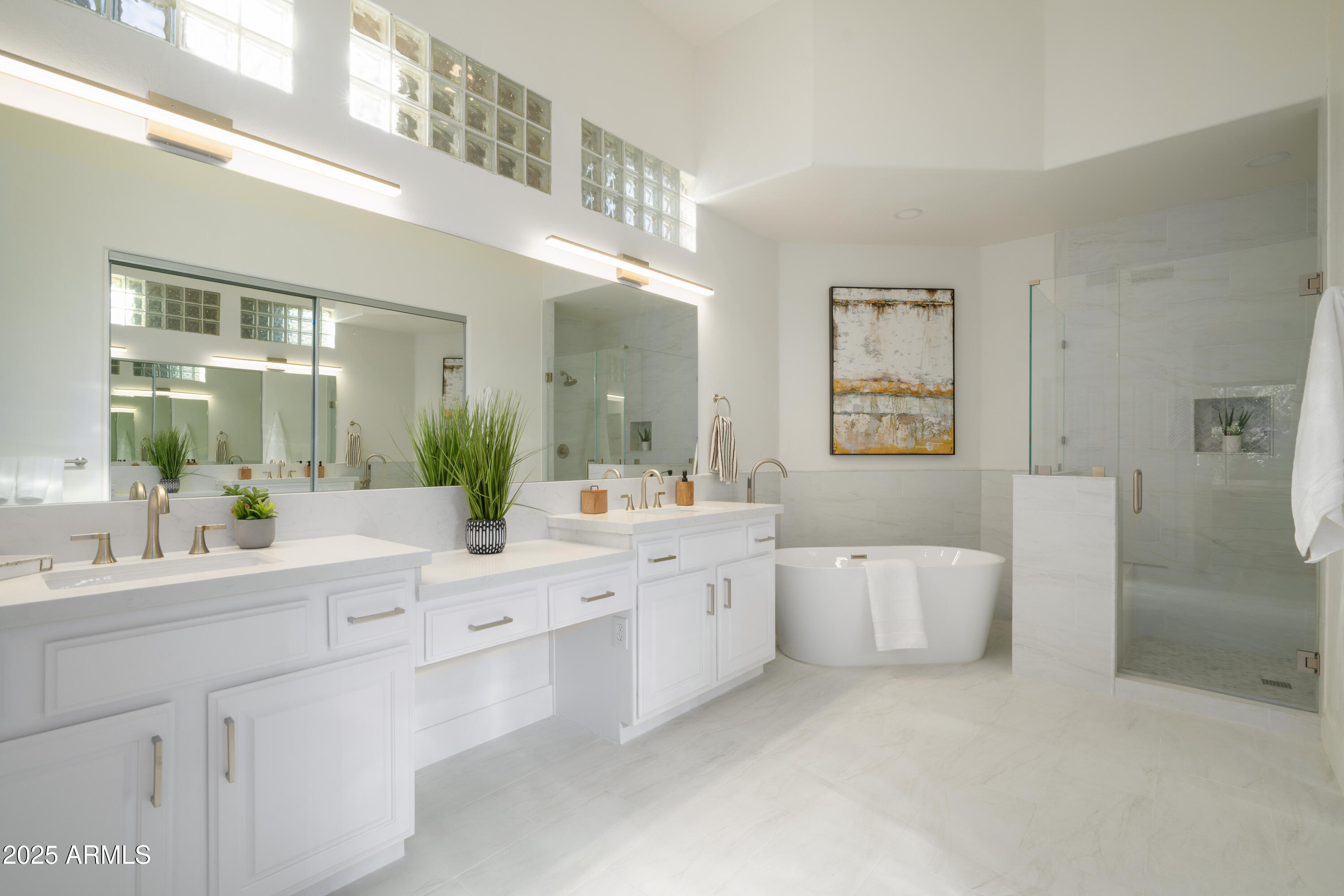 8100 East Camelback Road, Unit 175 Scottsdale, AZ 85251 - Photo 17 of 25 a large white bathroom with a double vanity sink a mirror and a bathtub