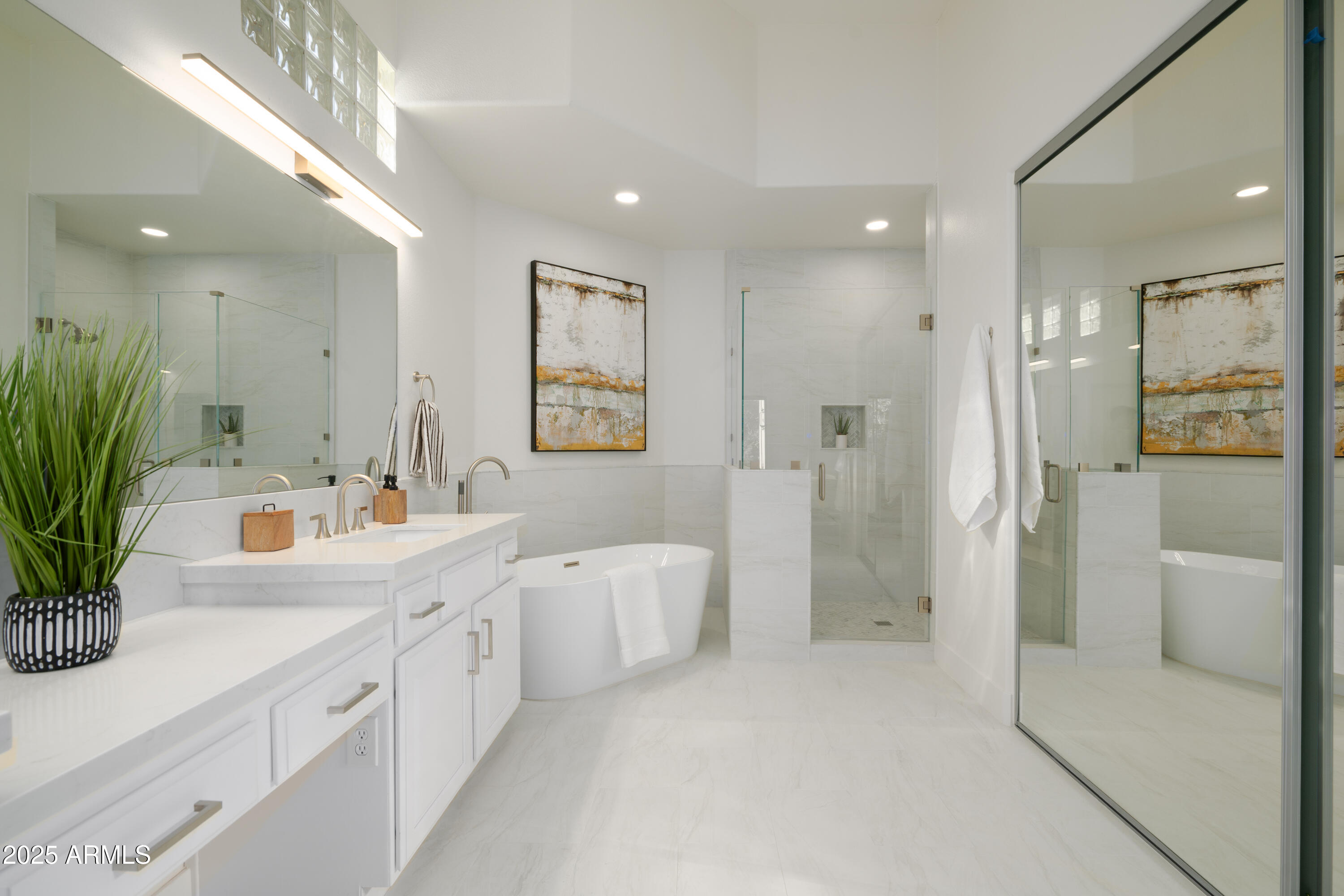 8100 East Camelback Road, Unit 175 Scottsdale, AZ 85251 - Photo 18 of 25 a large white bathroom with a double vanity sink a large mirror a shower and bathtub
