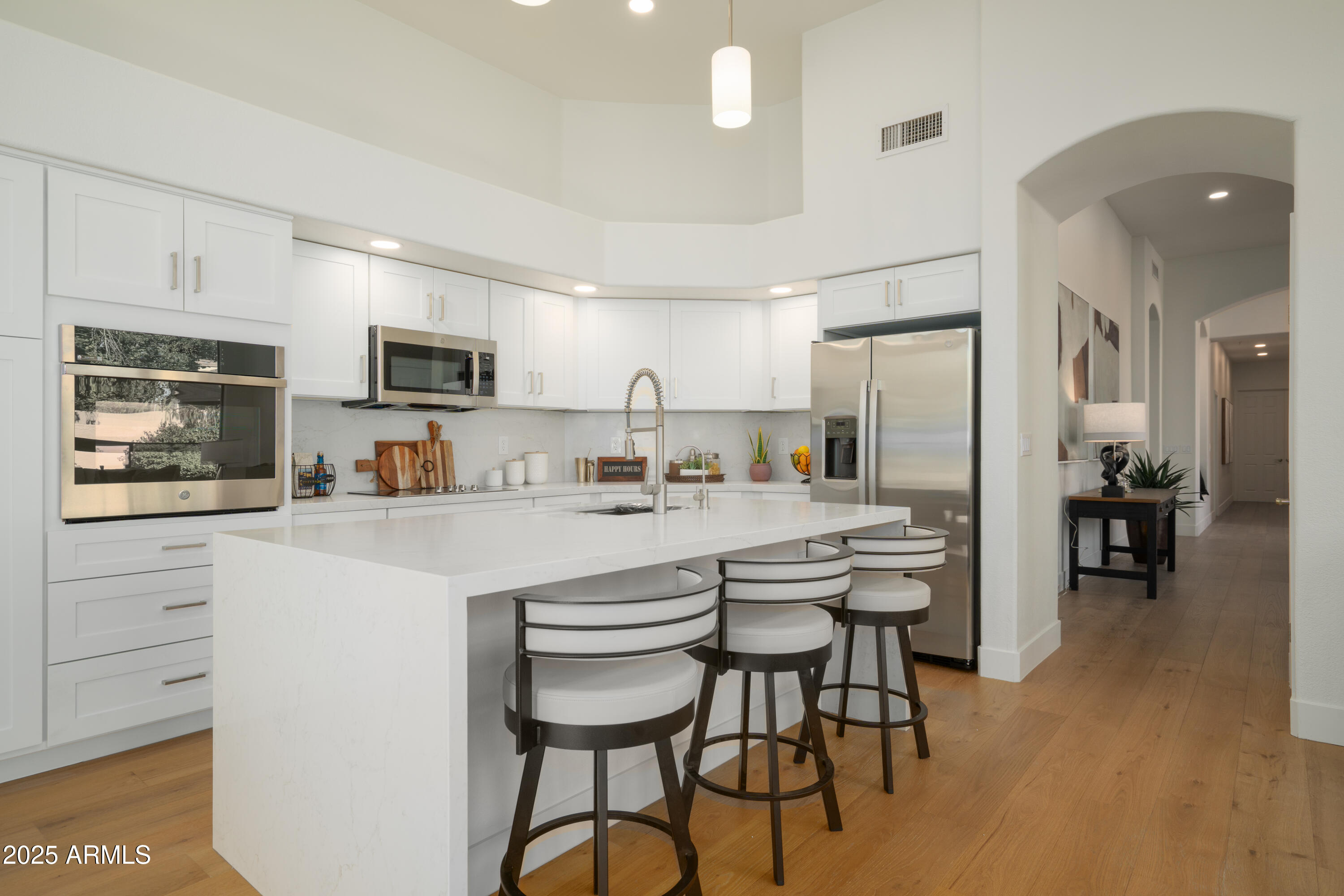8100 East Camelback Road, Unit 175 Scottsdale, AZ 85251 - Photo 4 of 25 a kitchen with kitchen island granite countertop a center island stainless steel appliances and cabinets