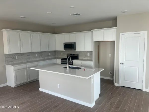 a white refrigerator freezer sitting inside of a kitchen