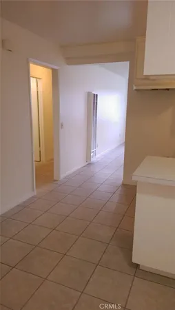 a room with white cabinets and sink