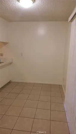 a bathroom with a granite countertop toilet a sink and a mirror