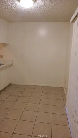 a bathroom with a granite countertop toilet a sink and a mirror