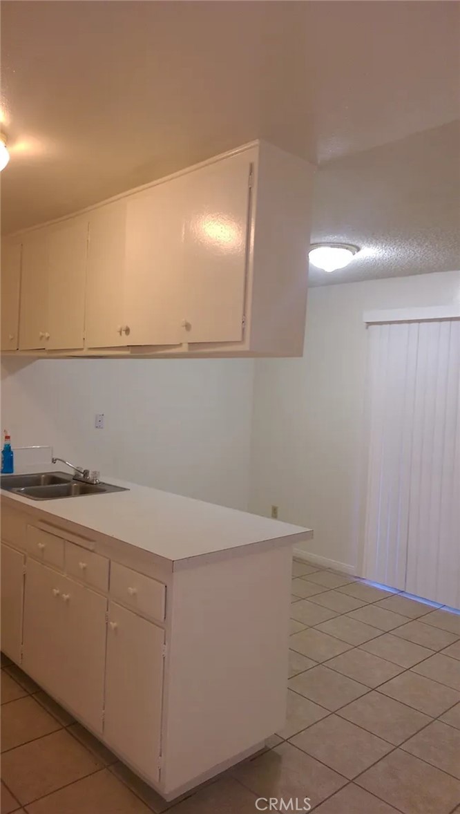 160 West Cascade Drive Rialto, CA 92376 - Photo 14 of 28 a room with white cabinets and sink