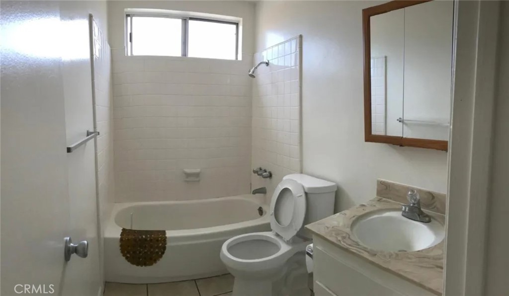 160 West Cascade Drive Rialto, CA 92376 - Photo 24 of 28 a bathroom with a granite countertop toilet sink and mirror