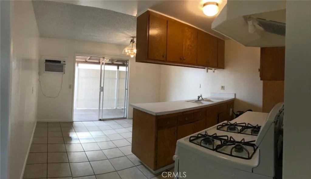 160 West Cascade Drive Rialto, CA 92376 - Photo 26 of 28 a kitchen with granite countertop a stove and a sink