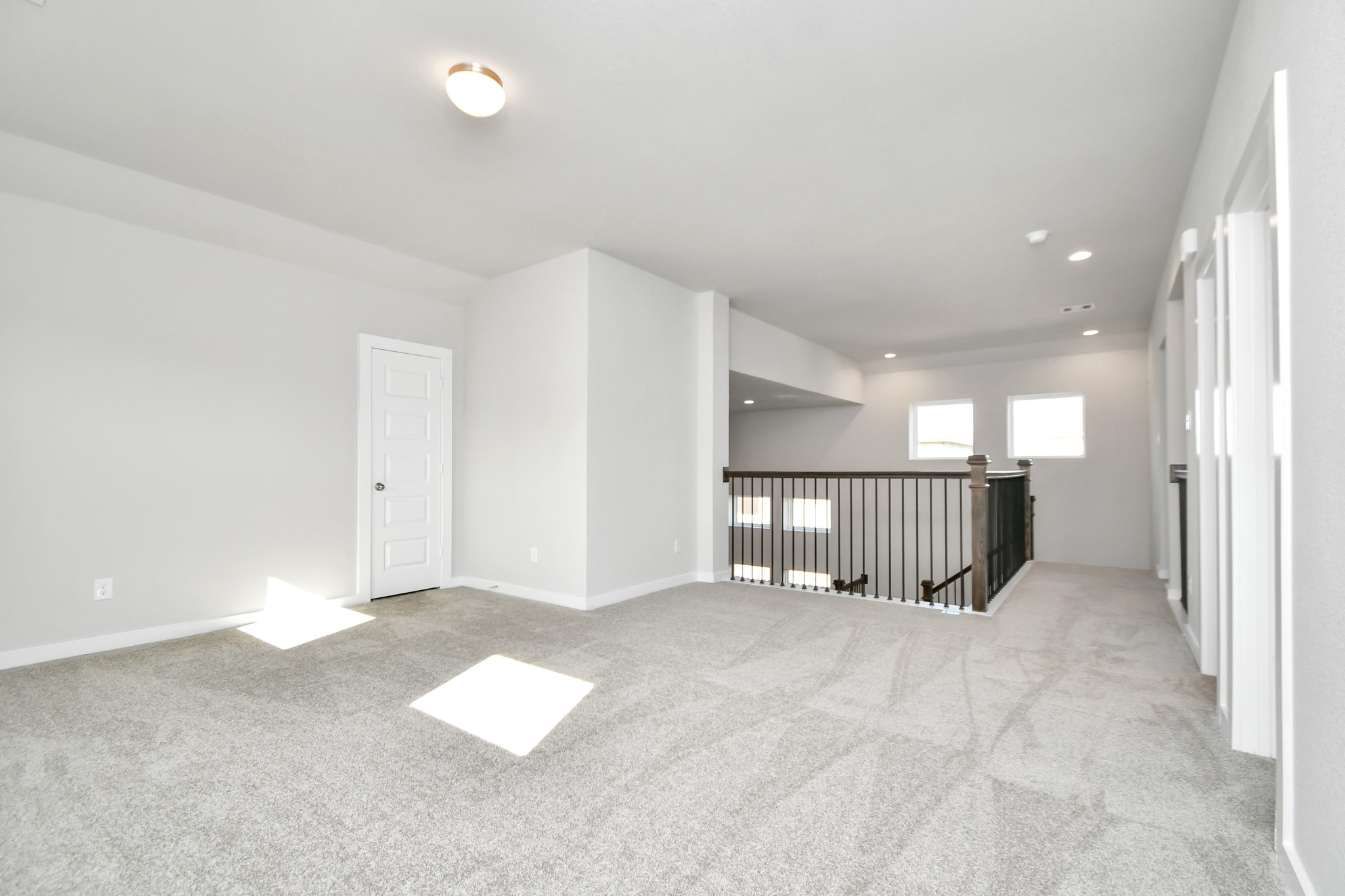 2954 Burris Park Drive Spring, TX 77373 - Photo 23 of 30 Come upstairs and relish a day of relaxation in this loft area! Ideal as an additional living space or game room, it boasts plush carpeting, high ceilings, custom paint, and windows that flood the area with abundant natural light. Sample photo of completed home with similar floor plan. As-built interior colors and selections may vary.