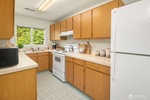 a kitchen with a sink cabinets and window