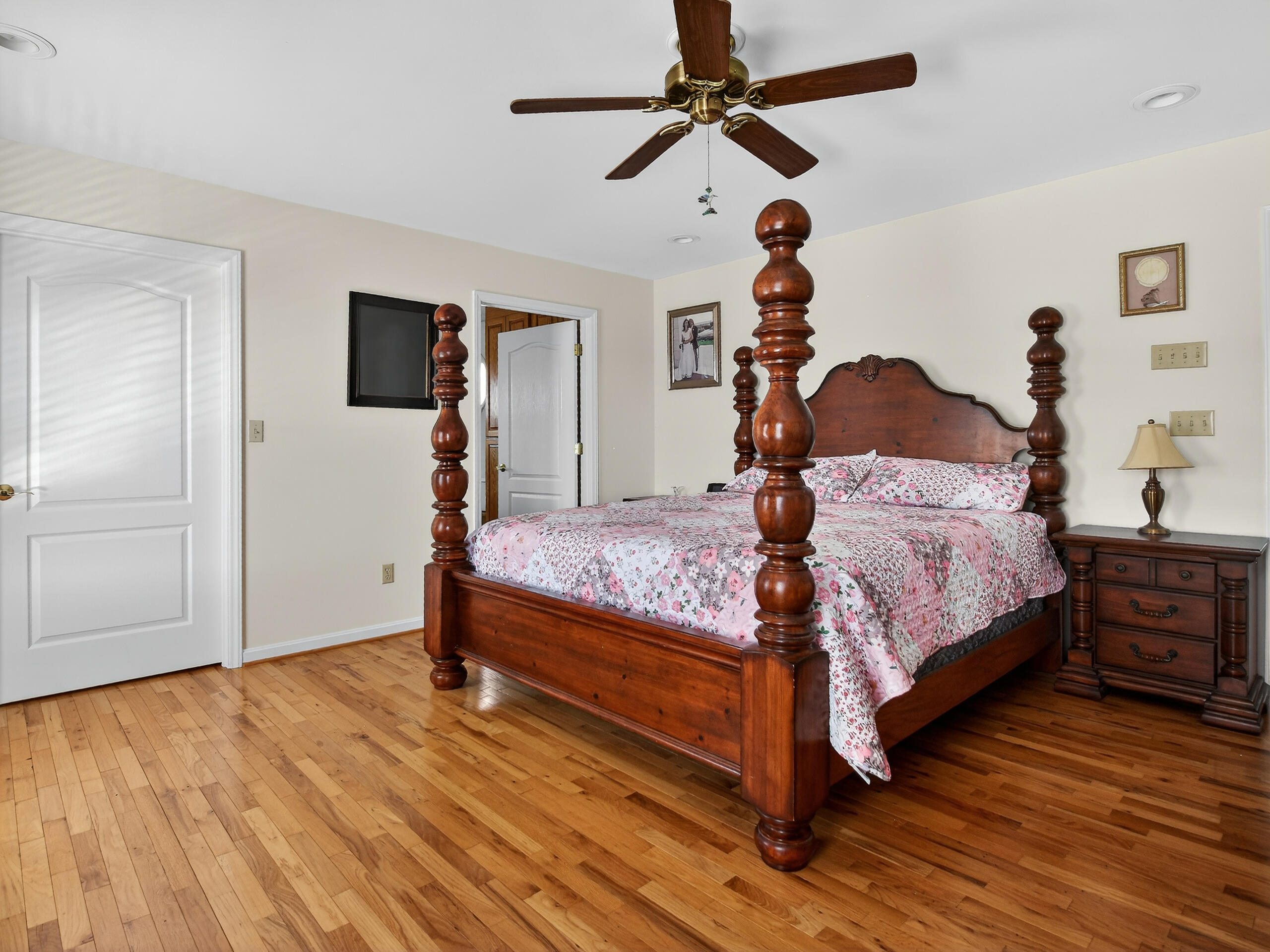 498 Meeks Road Penhook, VA 24137 - Photo 21 of 74 a bedroom with a bed a dresser and wooden floor
