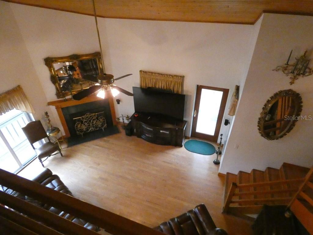 5260 Tuna Lane Weeki Wachee, FL 34607 - Photo 12 of 34 a bedroom with furniture and a flat screen tv