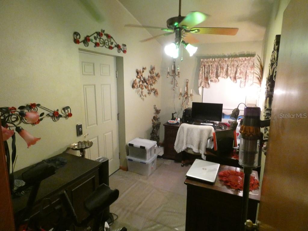 5260 Tuna Lane Weeki Wachee, FL 34607 - Photo 13 of 34 a bedroom with a bed and furniture