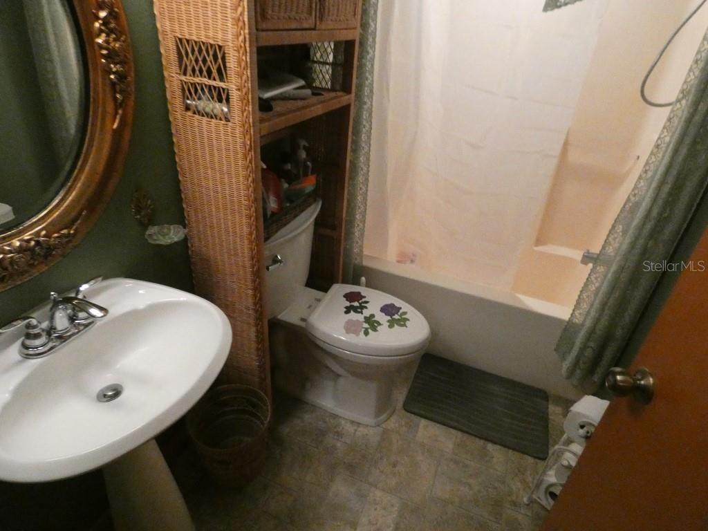 5260 Tuna Lane Weeki Wachee, FL 34607 - Photo 14 of 34 a bathroom with a sink and mirror with toilet