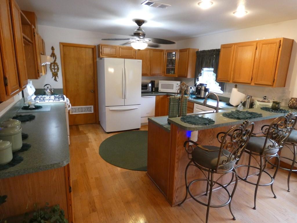 5260 Tuna Lane Weeki Wachee, FL 34607 - Photo 16 of 34 a kitchen with a sink appliances and cabinets
