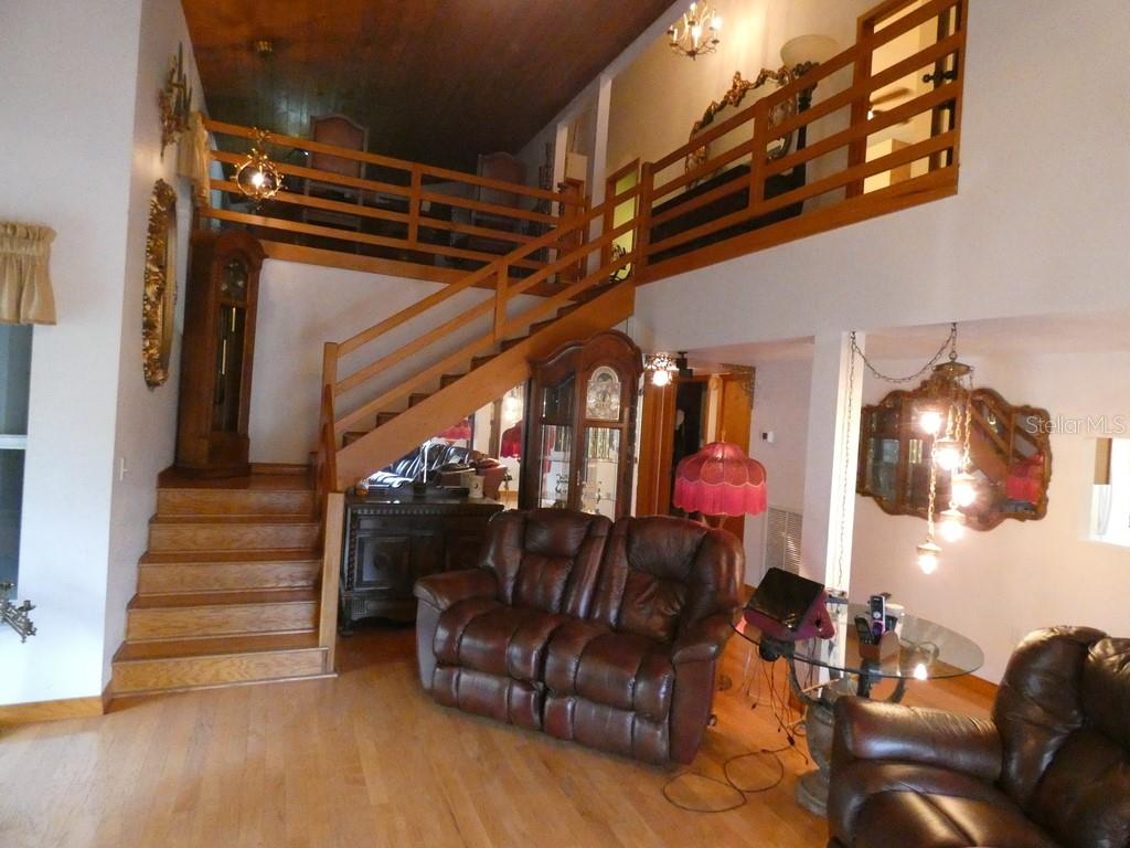 5260 Tuna Lane Weeki Wachee, FL 34607 - Photo 27 of 34 a living room with furniture and a chandelier