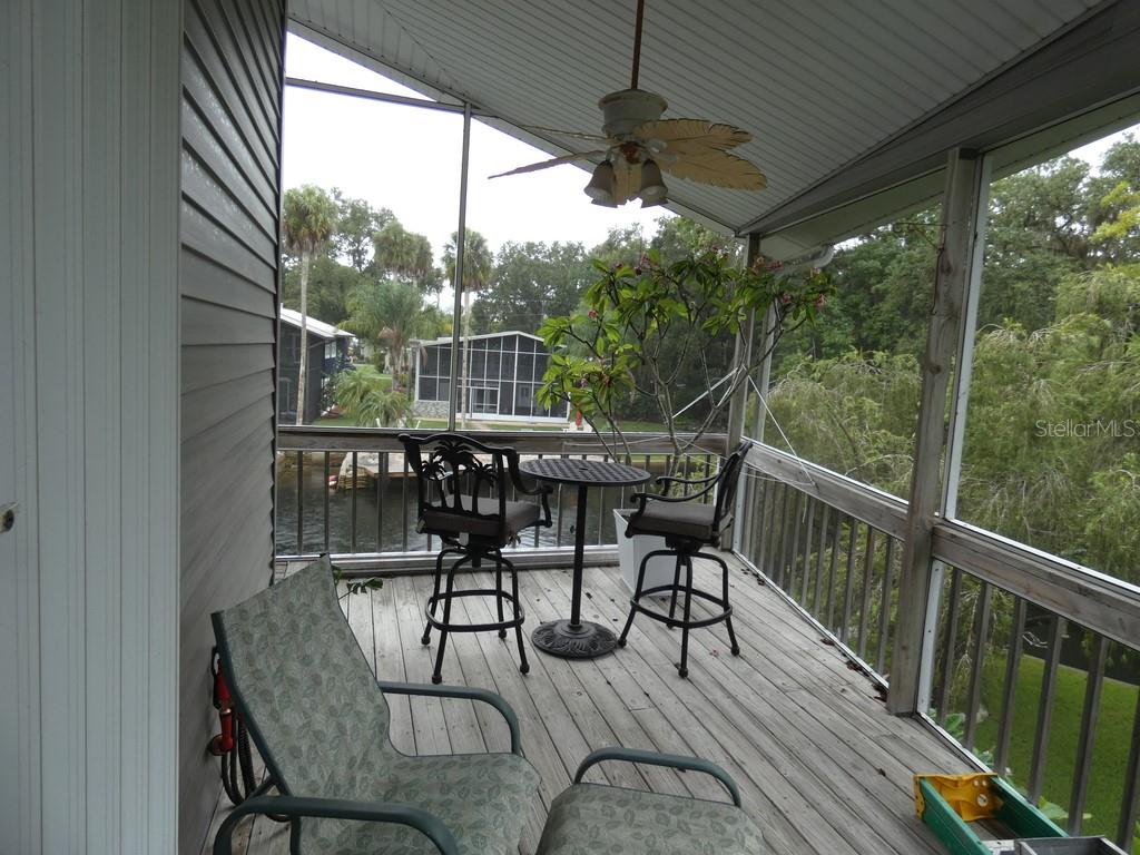 5260 Tuna Lane Weeki Wachee, FL 34607 - Photo 3 of 34 a view of a roof deck with table and chairs