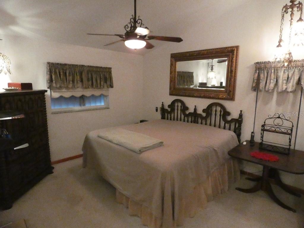 5260 Tuna Lane Weeki Wachee, FL 34607 - Photo 8 of 34 a bedroom with a bed and a flat screen tv