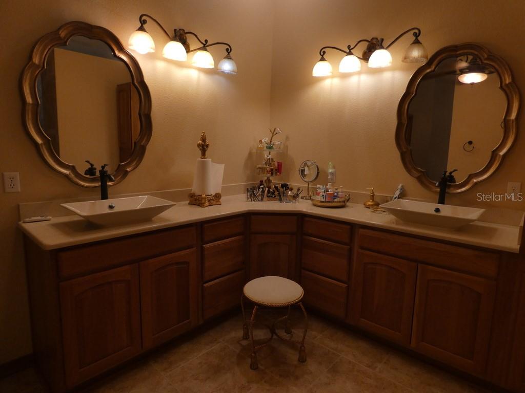5260 Tuna Lane Weeki Wachee, FL 34607 - Photo 9 of 34 a bathroom with a double vanity sink and a mirror